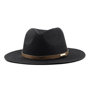 Detail of black straw fedora showing fine weave texture and brown leather band buckle