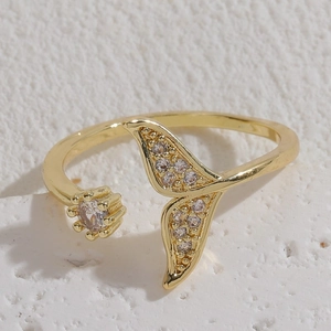 Elegant gold-plated mermaid tail open ring with sparkling zircon stones on marble
