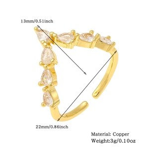 Detail view of V-shaped gold ring with zircon stones, copper material, 13x22mm size specs