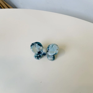 Detailed macro view of the marble blue acetate bow hair clip with sparkling rhinestones
