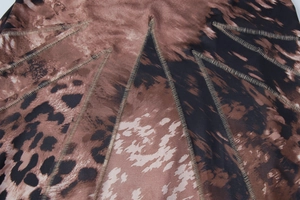 Close-up of leopard print fabric with precise stitching details on women's dress