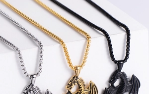 Detailed view of punk dragon pendants in silver, gold, and black finishes with box chains