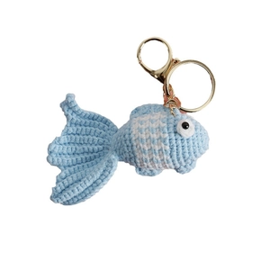 Handmade crochet goldfish keychain in blue and white yarn with a gold metal ring
