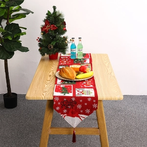 Detailed view of red Christmas table runner with reindeer and snowflake patterns