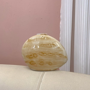 Macro view of minimalist marble-patterned ceramic vase with glossy finish in modern style