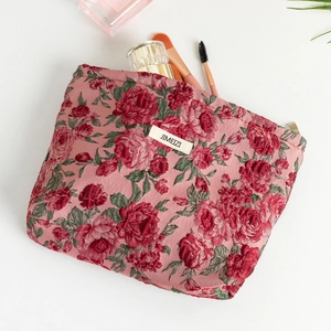 Close-up of pink rose jacquard toiletry bag with embroidery texture and JIMEIZI label