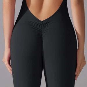 Macro detail of ruched back seam on black high-stretch bodycon yoga jumpsuit