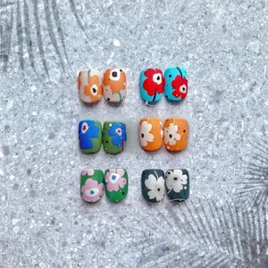 Detailed view of matte floral nail stickers in vibrant French summer style patterns