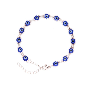 Macro shot of rose gold Evil Eye bracelet with blue beads and adjustable lobster clasp