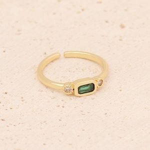 Detail of adjustable gold ring with emerald-cut green stone and side zircon accents