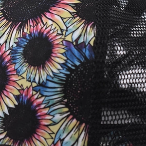 Close-up of vibrant sunflower floral print and breathable black mesh on ponytail baseball cap