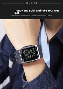 Macro shot of a black digital sports watch with a silver metal frame on a male wrist