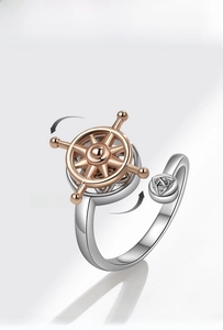 Detailed view of nautical steering wheel rotating ring with silver and rose gold finish