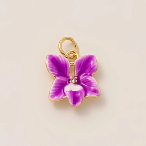 Detailed macro view of purple orchid pendant with gold plating and crystal stamen