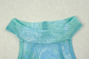 Detail of elegant mesh sleeveless dress with marble print and chic high neckline