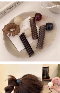 Detailed view of bubble hair ties with acrylic beads and spiral telephone wire texture