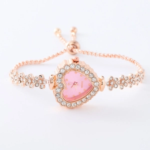 Macro view of heart-shaped rose gold ladies watch with pink dial and rhinestone bracelet