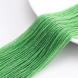 Macro shot of 32-facet green crystal glass beads for DIY jewelry making and curtains