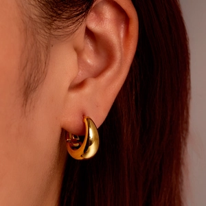 Elegant 18k gold plated stainless steel U-shaped crescent earrings worn by a model