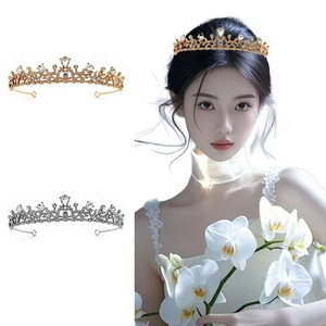Detail of elegant gold and silver rhinestone flower tiaras on a child model with white orchids