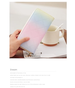 Quilted gradient leather wallet held over a coffee table with stylish magazine background