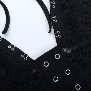Vue détaillée de la dentelle noire avec crochets métalliques argentés et œillets de fixation
