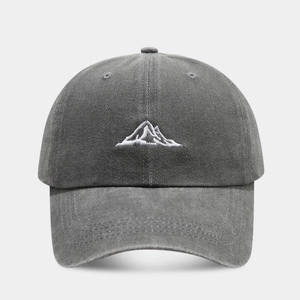Close-up of mountain embroidery and vintage washed fabric texture on the baseball cap
