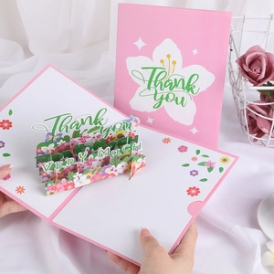 3D pop-up thank you card with pink floral and butterfly designs on a white gauze background