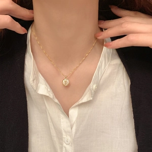 French style gold necklace featuring a round white mother-of-pearl horse relief pendant