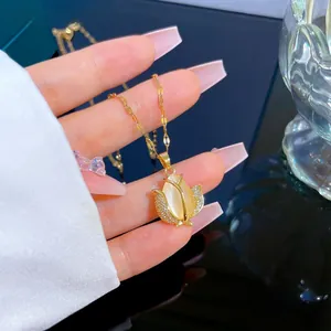 Detailed close-up of tulip pendant with opal stone and sparkling zircon on golden chain