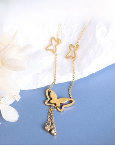 Detail of gold butterfly pendant with elegant tassels and cubic zirconia accents