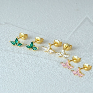Detailed close-up of diamond butterfly stud earrings in green, white, and pink zircon