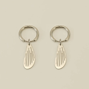 Detailed view of silver stainless steel hoop earrings featuring hollow wing-shaped pendants