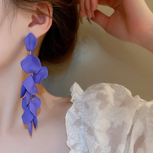 Close-up of matte purple multi-layered rose petal long tassel earrings on model