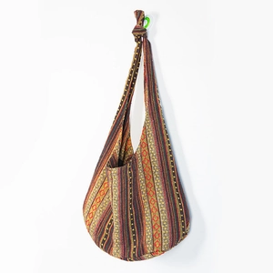 Detail of bohemian crossbody bag showing ethnic striped patterns and woven fabric textures