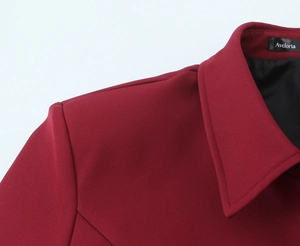 Detail of red blazer showing high-quality woven fabric texture and precision stitching