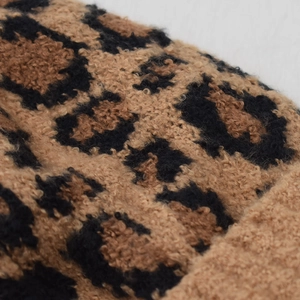 Close-up of soft fluffy leopard print fabric with high-quality plush texture detail