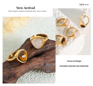 Detail of rose quartz and tiger eye stones set in gold plated stainless steel rings