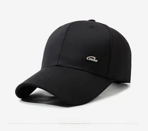 Detail of black cotton baseball cap showing silver metal SPORT tag and twill fabric texture