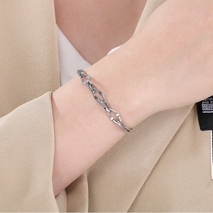 Close-up of geometric stainless steel linked chain bracelet with silver finish on model