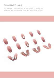 Detailed view of pink gradient press-on nails with silver glitter and 3D heart rhinestones