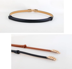 Detail of thin faux leather belts with gold leaf buckle in black and brown finishes