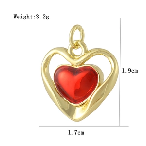 Detail view of 18K gold plated heart pendant with red inlay and 1.9x1.7cm size scale