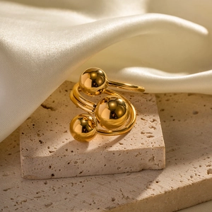Exaggerated 18K gold-plated stainless steel ring with three spheres on stone base