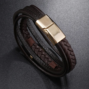 Detail of dark brown leather braided multi-layer bracelet with gold magnetic clasp