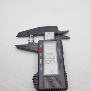 Digital caliper measuring a 13.6 mm silver hollow metal flower bead cap accessory