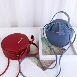 Red and blue round leather crossbody bags with litchi texture and golden metal logo