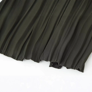 Dark green pleated midi dress with fine accordion folds and belt detail in a flowy design