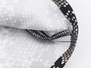 Close-up of snake print satin midi skirt showing high-quality overlock stitching details