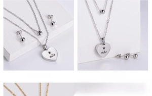 Macro shot of silver plated heart pendant with 'mãe' engraving and round stud earrings